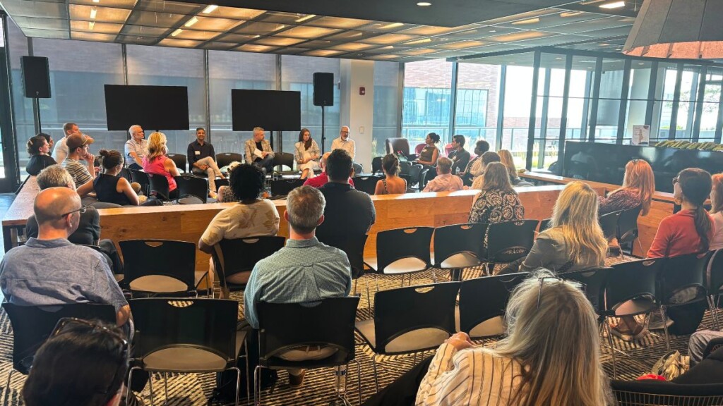 Photo of the inaugural AI Marketing Forum showing a sizable audience listening to 4 AI experts in the VML meeting room